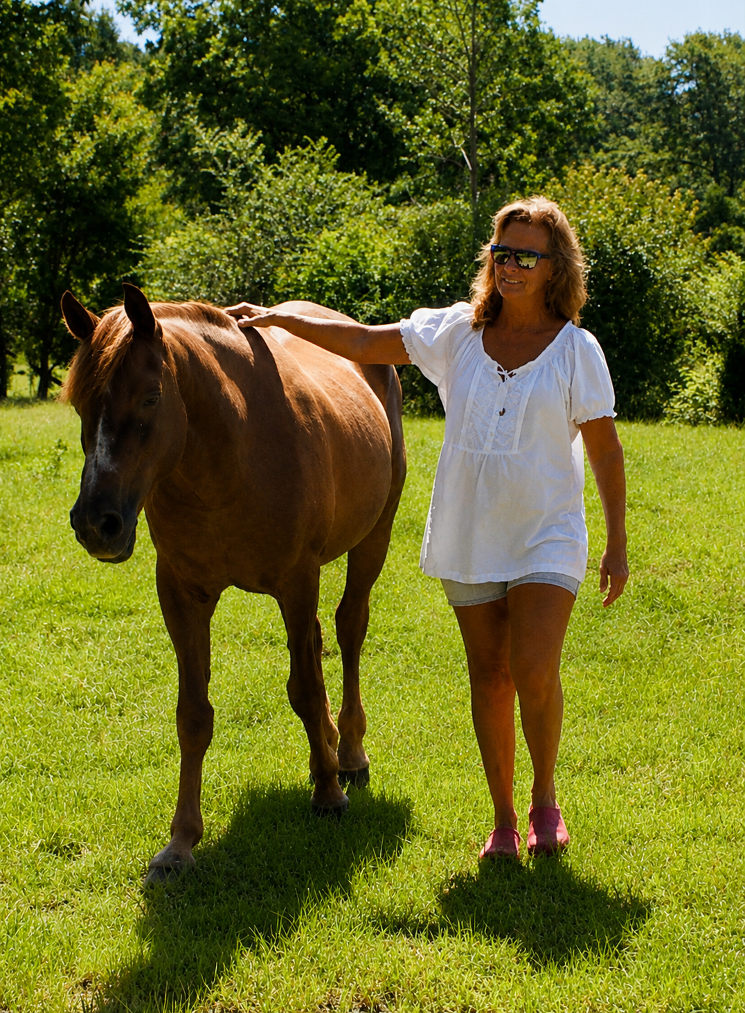Nita Kay walking beside a horse